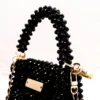 BOLSA MINI DE CRISTAL NEGRO BRILLANTE CON AZA NEGRA Y MARCA DORADA